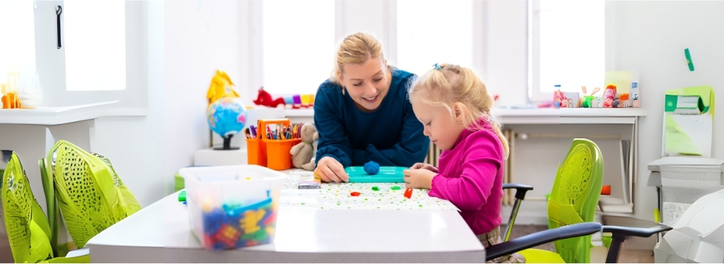 A person is helping a child with a craft project