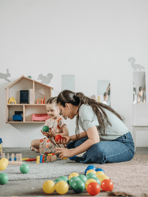 A child playing with toys in a playroom.